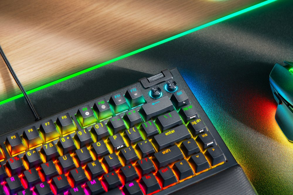 A keyboard with rainbow colored lights

Description automatically generated