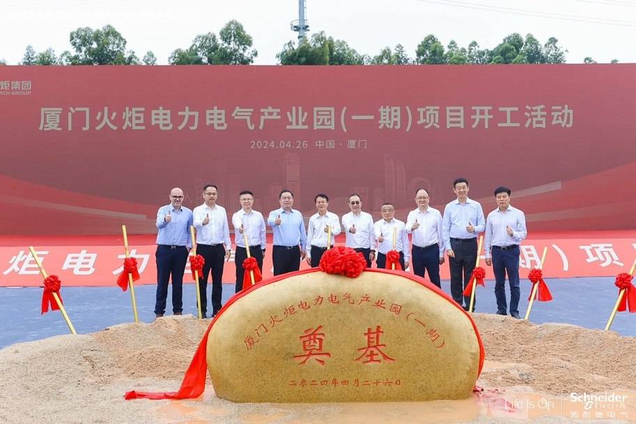 A group of men standing in front of a large rockDescription automatically generated