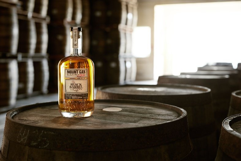 A bottle of alcohol on a barrel

Description automatically generated